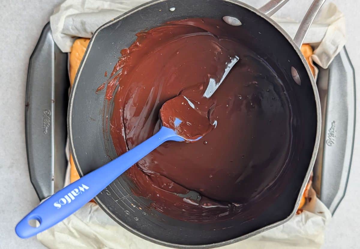 making ganache topping with melted chocolate chips and heavy cream