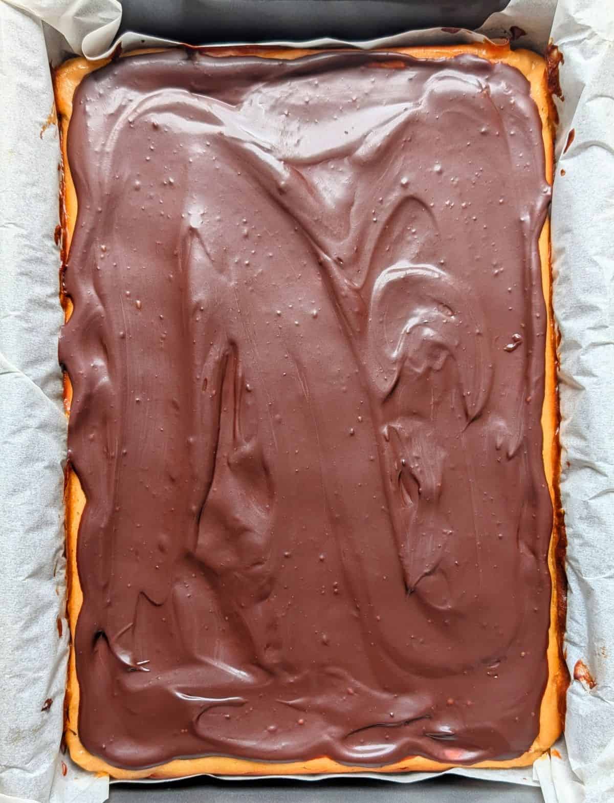 peanut butter cheesecake bars in pan before slicing