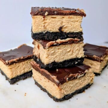 peanut butter cheesecake bars stacked on plate