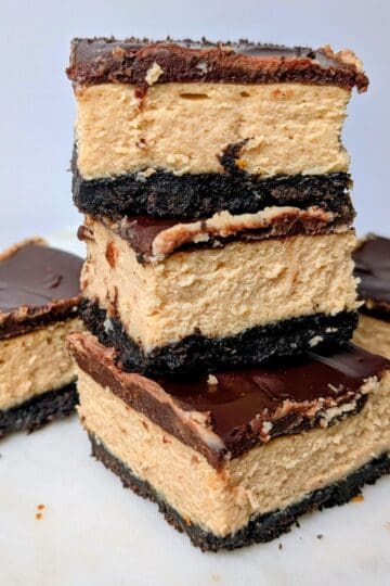 peanut butter cheesecake bars stacked on plate