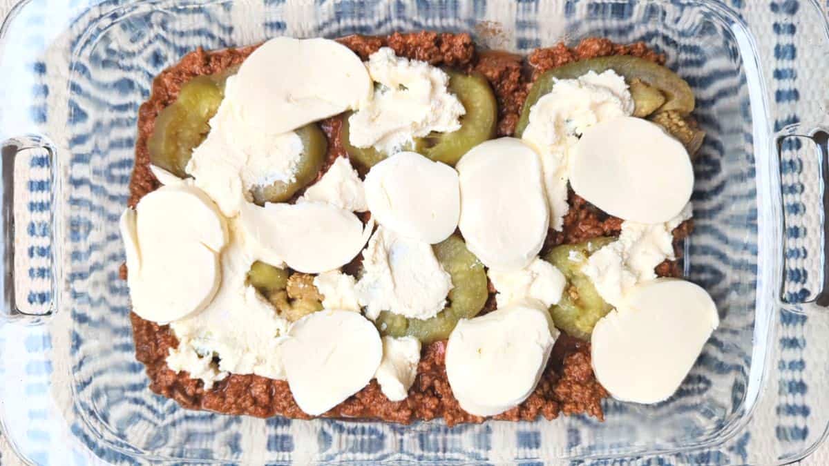 Layering fresh mozzarella and ricotta cheese to build an easy eggplant casserole.