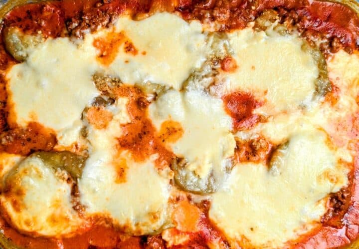 A freshly baked three cheese eggplant casserole in a baking dish.