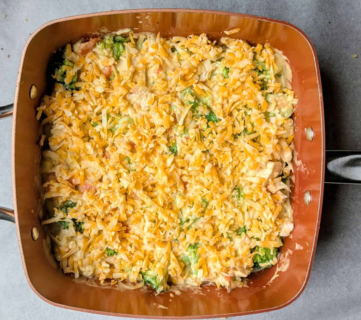 sprinkling shredded cheese on top