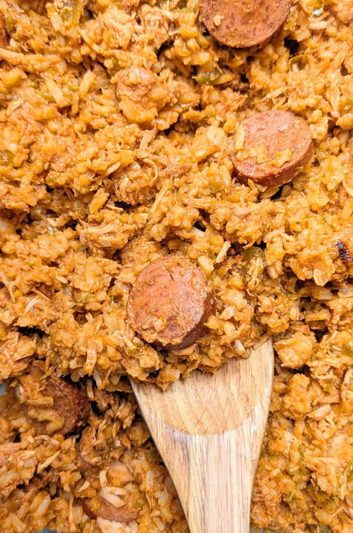 spooning chicken and ham jambalaya for serving