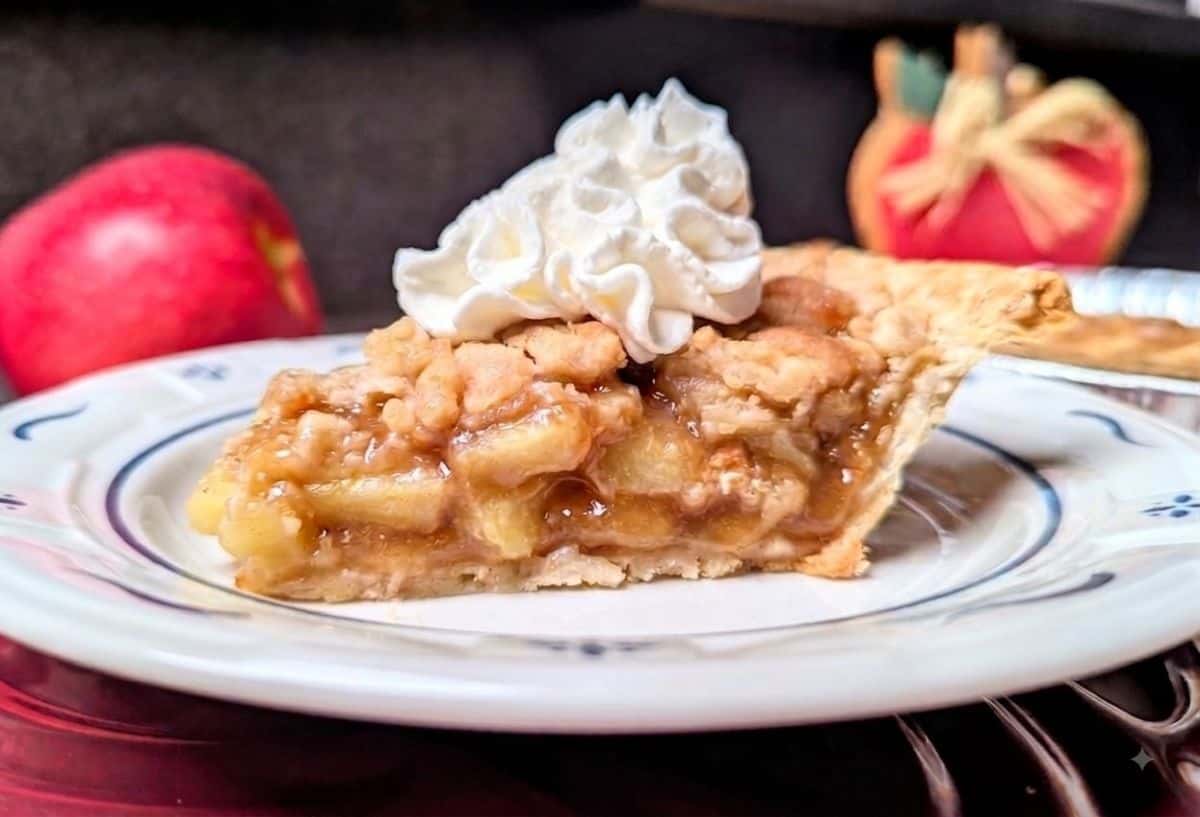 a slice of apple crumb pie on plate