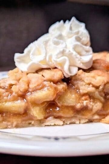 apple crumb pie on plate with whip
