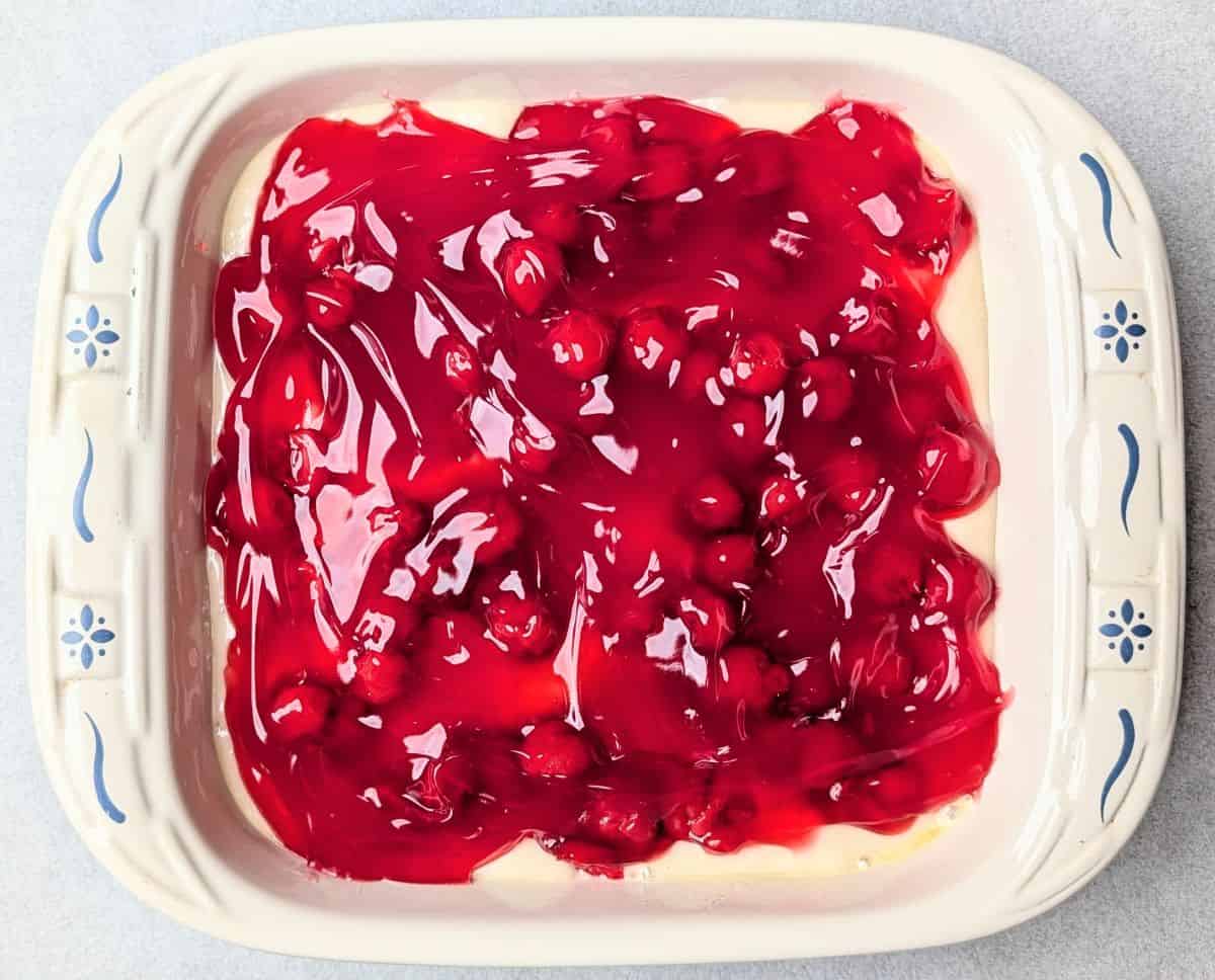 cherry pie filling spooned on top of cake batter