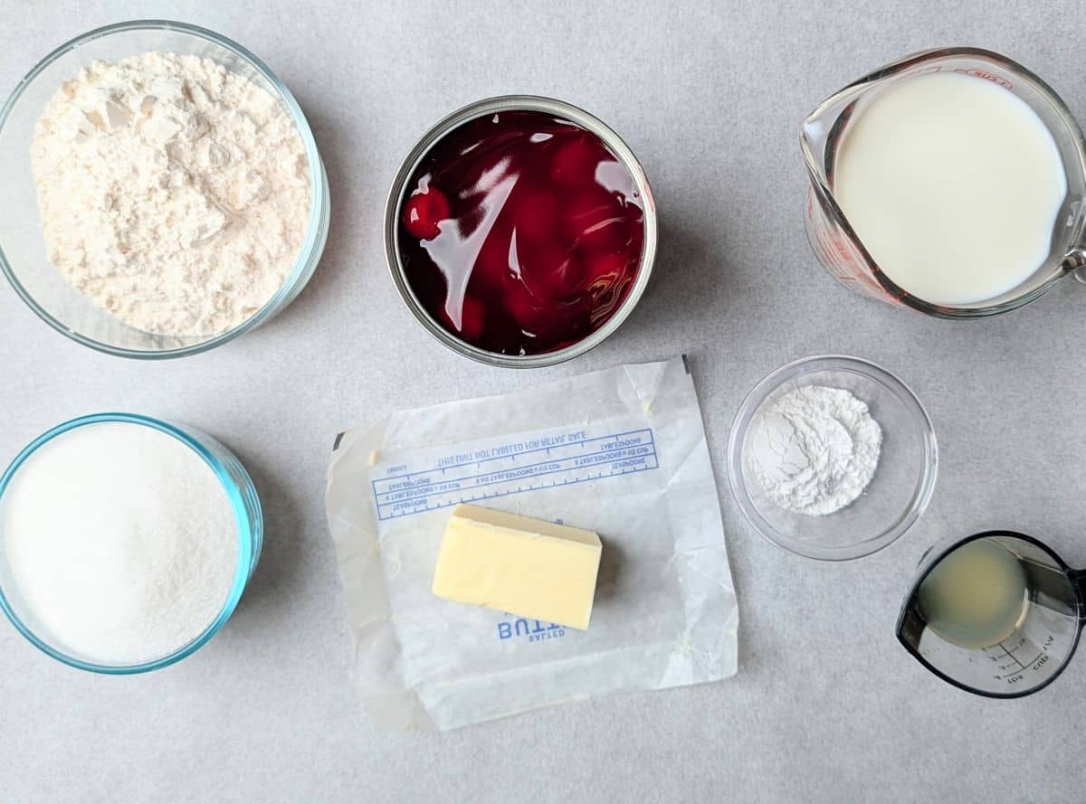ingredients needed to make the pudding cake, including a can of cherry pie filling