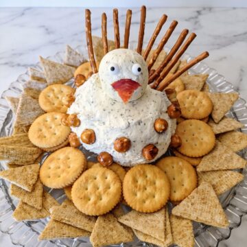 zesty turkey chees ball on serving platter with crackers
