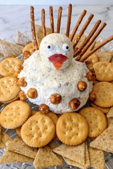zesty turkey chees ball on serving platter with crackers