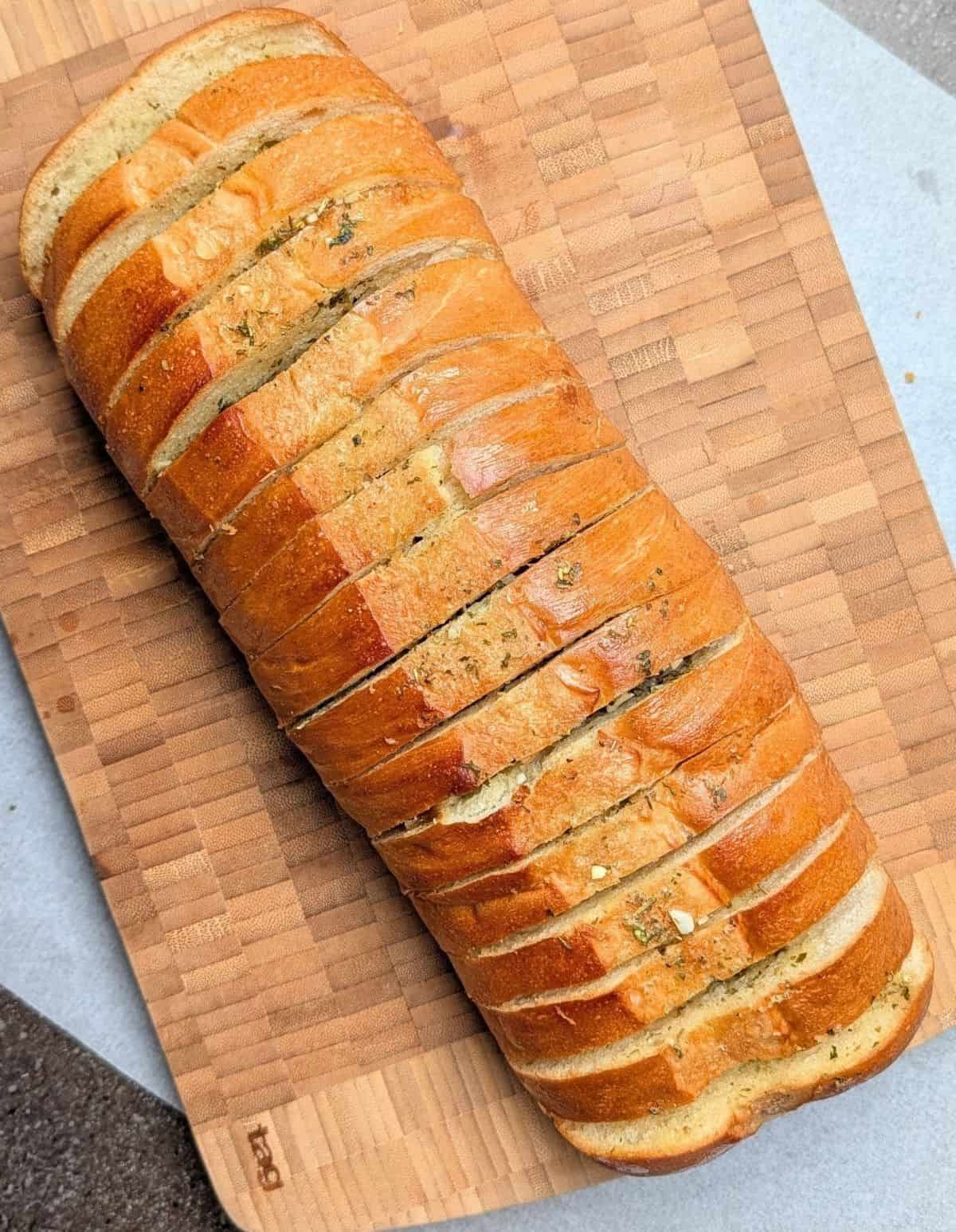 Golden brown, oven-baked simple garlic bread sliced and ready to serve.