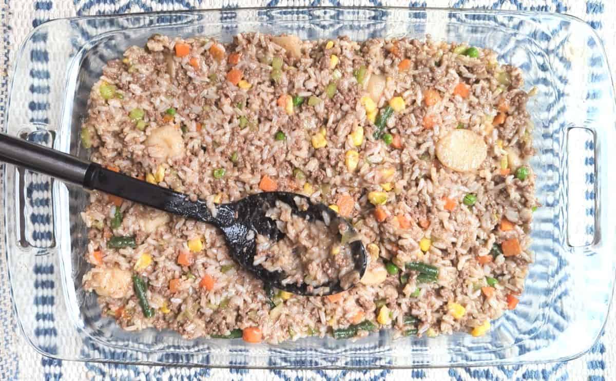 spreading ground beef and rice mixture into casserole