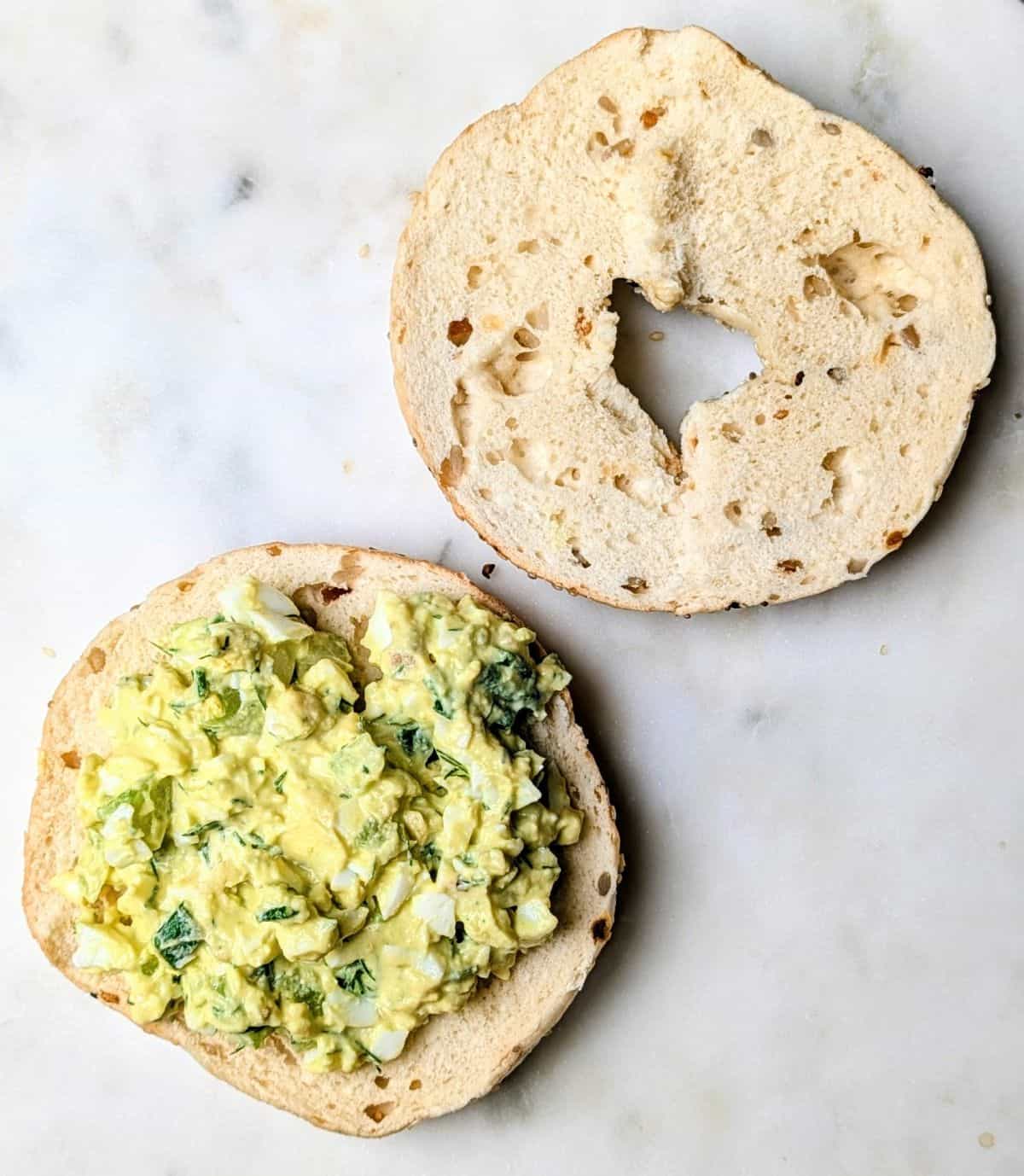 bagel open with salad on one half