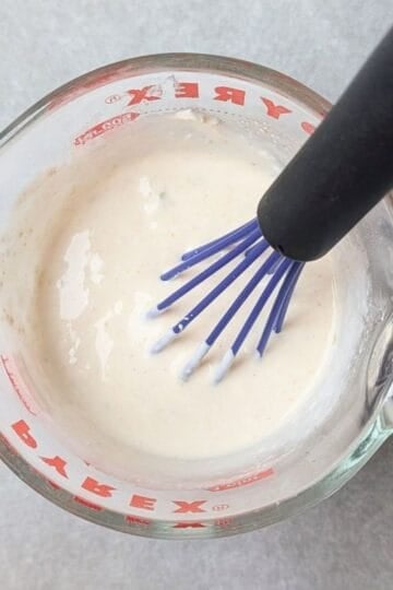whisking cream cheese into warm broth so it doesn't curdle