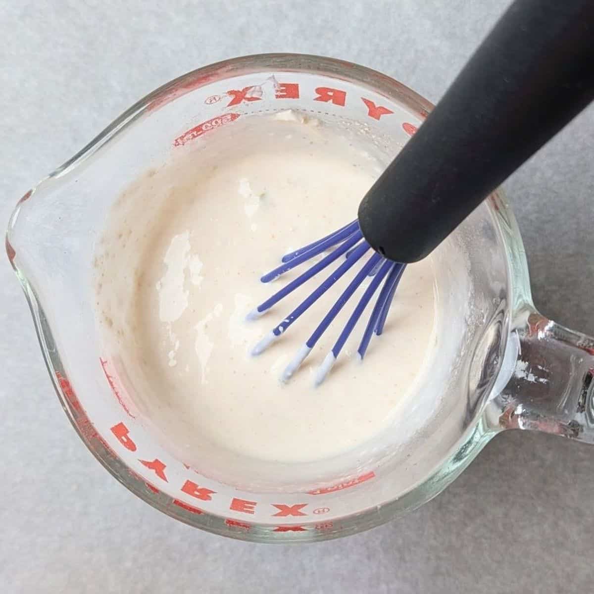 whisking cream cheese into warm broth so it doesn't curdle